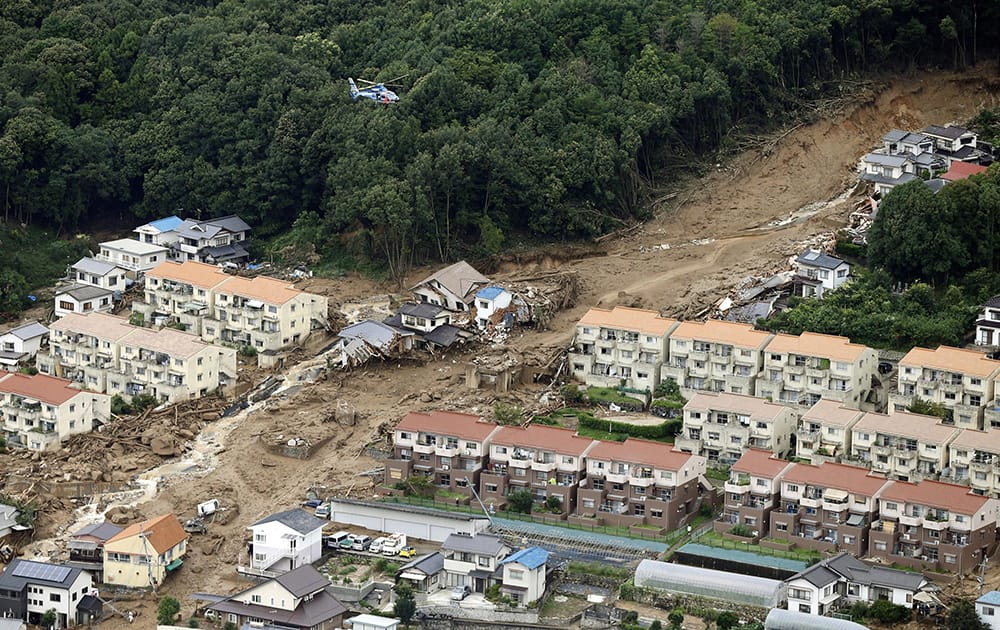 A rescue helicopter hovers over an area devastated by a massive landslide in Hiroshima, western Japan.