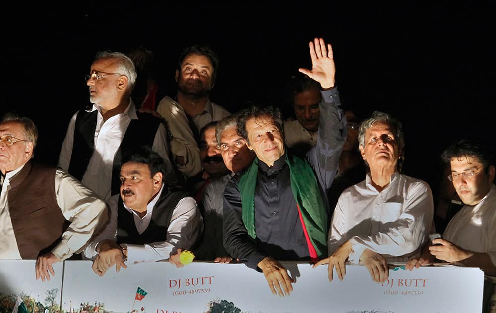 Pakistan`s cricketer-turned-politician Imran Khan waves to supporters as he leads a march toward parliament in Islamabad.