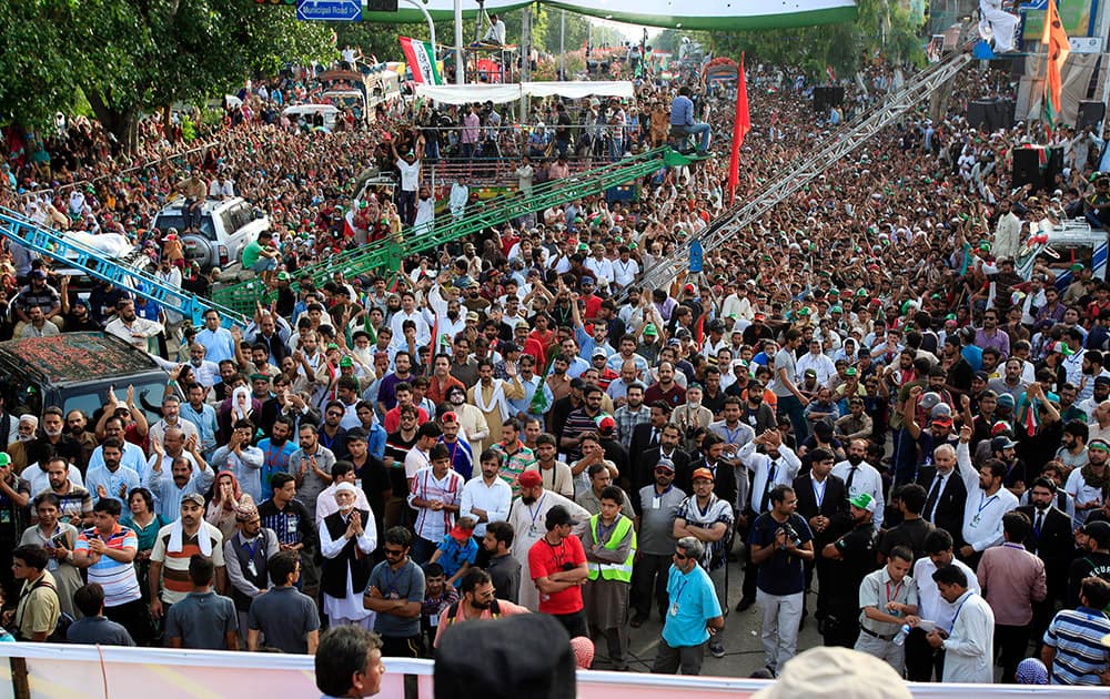 Supporters of Pakistan`s fiery anti-government cleric Tahir-ul-Qadri listen their leader at a rally in Islamabad, Pakistan.