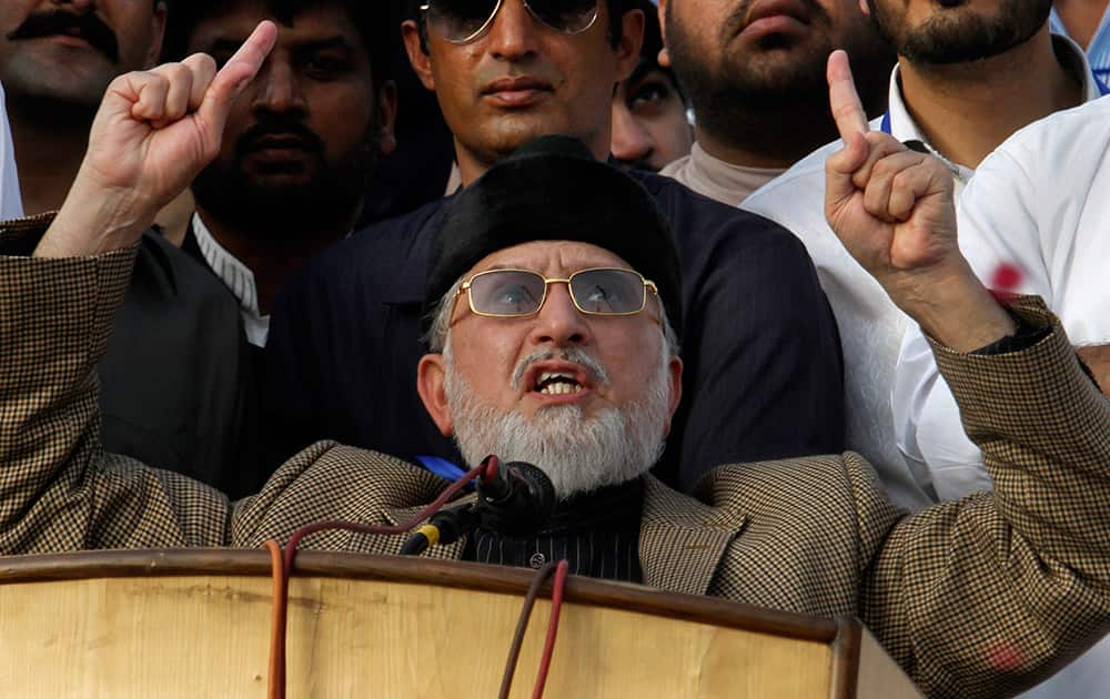 Pakistan`s fiery anti-government cleric Tahir-ul-Qadri gestures as he addresses to a rally in Islamabad.