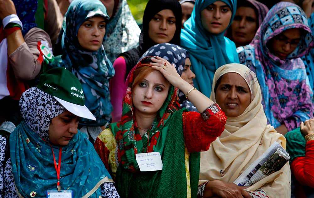 Women supporters of anti-government cleric Tahir-ul-Qadri wait for their leader during a protest, in Islamabad.