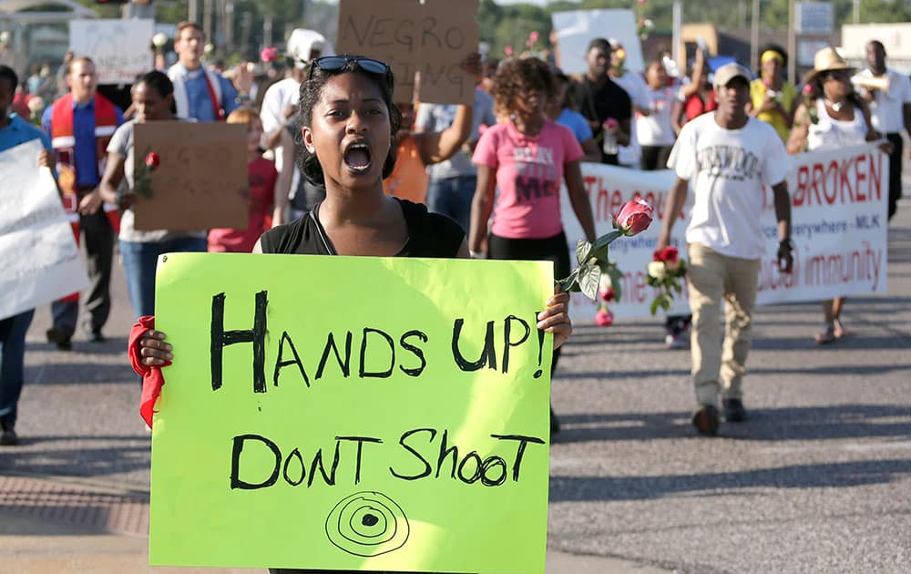 Protesters march for Michael Brown, who was killed by police Aug. 9 in Ferguson, Mo. Ferguson`s leaders urged residents Tuesday to stay home after dark to `allow peace to settle in` and pledged several actions to reconnect with the predominantly black community in the St. Louis suburb where the fatal shooting of 18-year-old Michael Brown has sparked nightly clashes between protesters and police. 