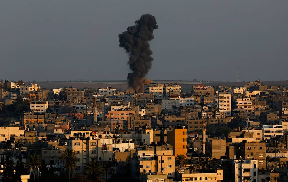 Smoke and dust rise after an Israeli strike hit Gaza City in the northern Gaza Strip.