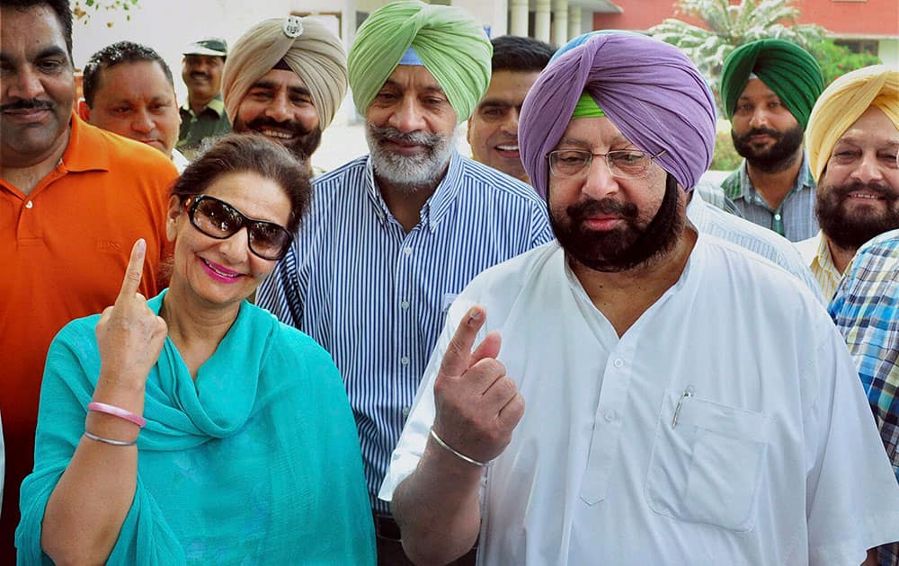 Former Punjab Chief Minister, Capt. Amrinder Singh and party candidate Preneet Kaur after casting votes for Patiala assembly bypoll, in Patiala.