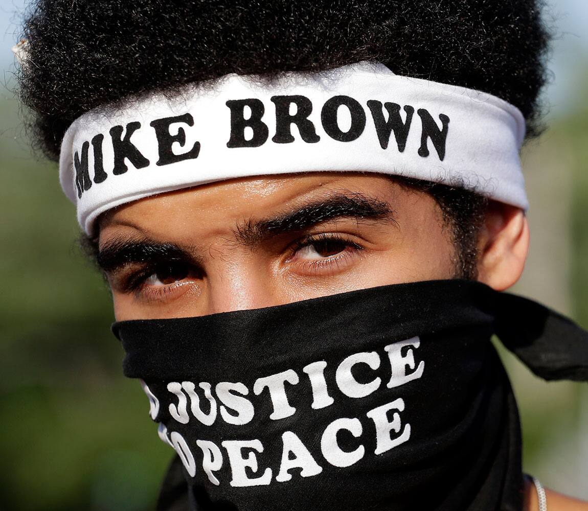 Quentin Baker, from Crystal City, Mo. watches during a protest Wednesday, Aug. 20, 2014, for Michael Brown, who was killed by police Aug. 9 in Ferguson, Mo. 