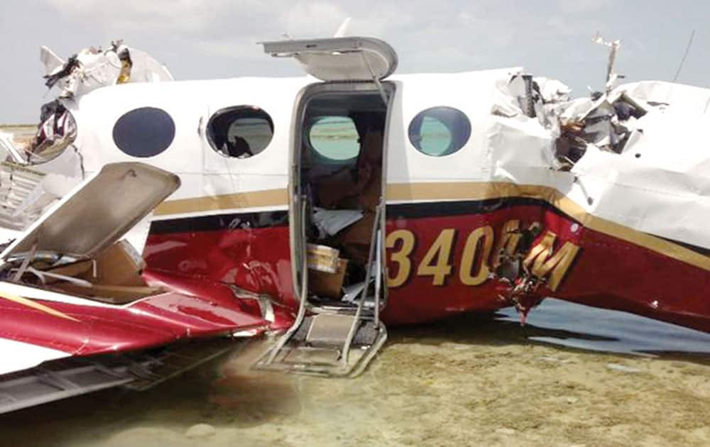 This Monday, Aug. 18, 2014 photo released by the Bahamas Air Sea Rescue Association (BASRA) shows the remains of a plane that crashed on approach to Freeport on the island of Grand Bahama. Police in the Bahamas say four men who died in a small plane crash in the island chain were from Florida. The plane had flown from Ormond Beach Municipal Airport near Daytona Beach. 