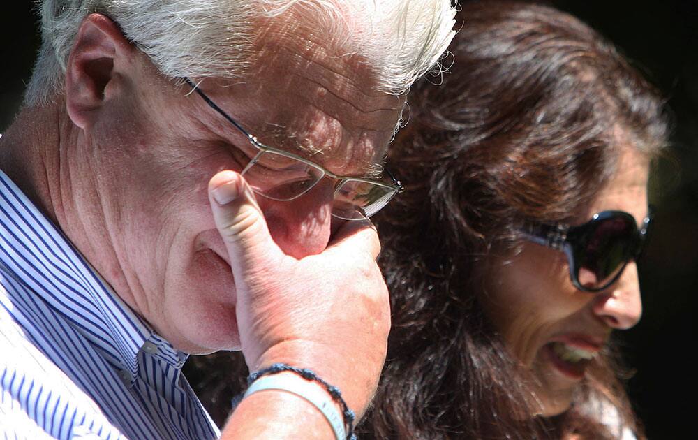 After speaking with US President Barack Obama by phone, John and Diane Foley talk to reporters, outside their home in Rochester, N.H. Their son James Foley was abducted in November 2012 while covering the Syrian conflict. Islamic militants posted a video showing his murder on Tuesday and said they killed him because the US had launched airstrikes in northern Iraq. 