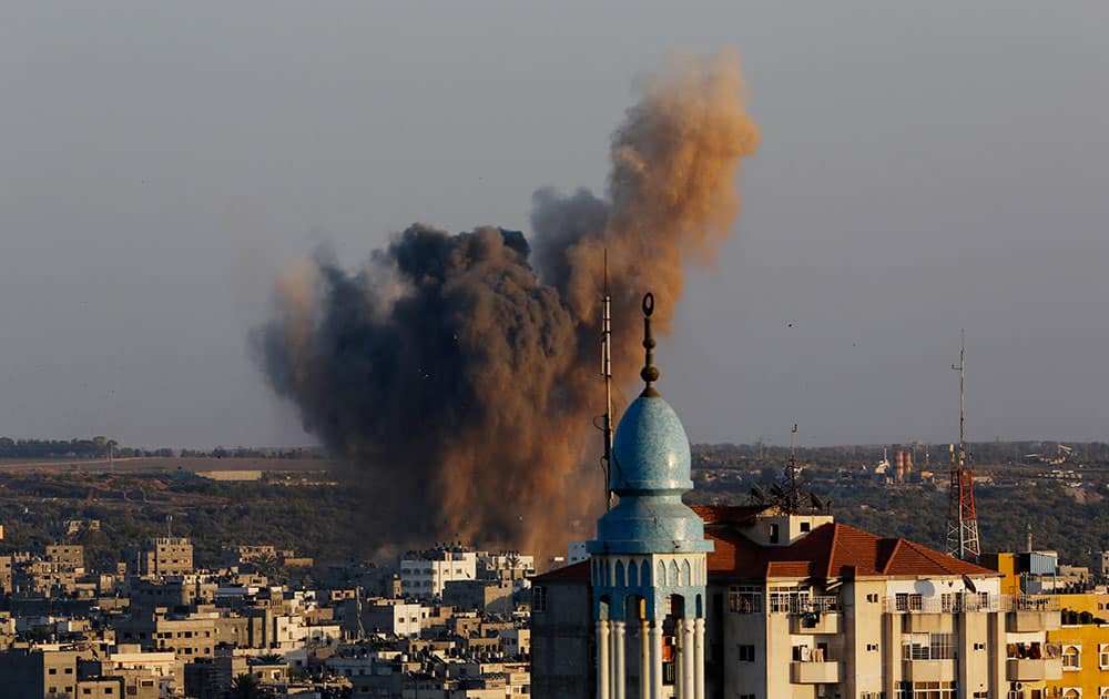 Smoke, dust and debris rise after an Israeli strike hit Gaza City in the northern Gaza Strip.