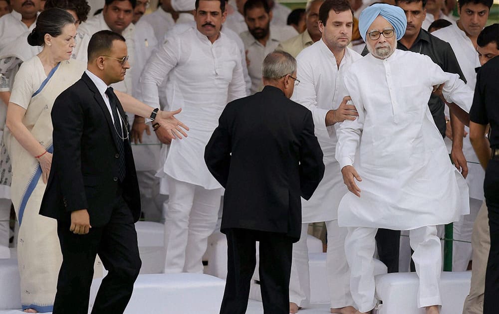 President Pranab Mukherjee and Congress President Sonia Gandhi look on as Congress party Vice President Rahul Gandhi offers support to former Prime Minister Manmohan Singh after he stumbles during a function on former Prime Minister Rajiv Gandhi`s birth anniversary at Vir Bhoomi in New Delhi.