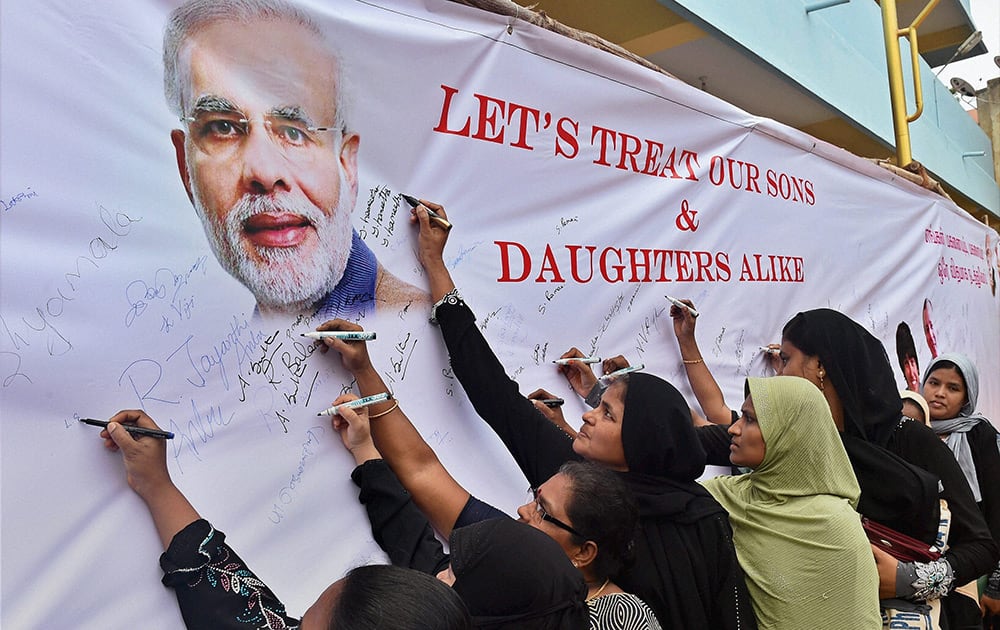 Parents signing a banner during the awareness campaign in Chennai.