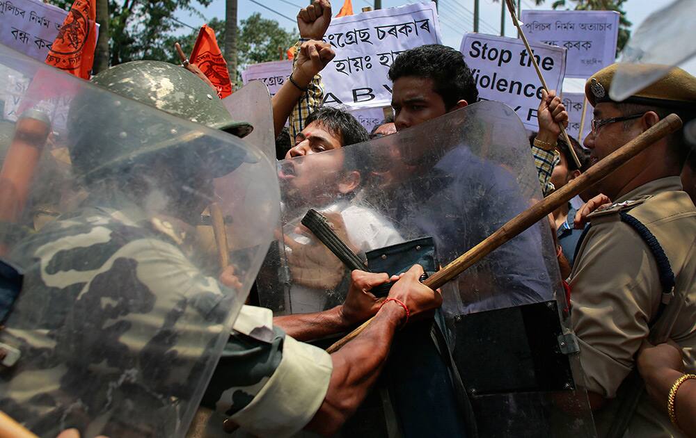 Police stop activists of Akhil Bharatiya Vidyarthi Parishad (ABVP) in Guwahati, Assam, as they protest against the ongoing violence in Golaghat town in the state.