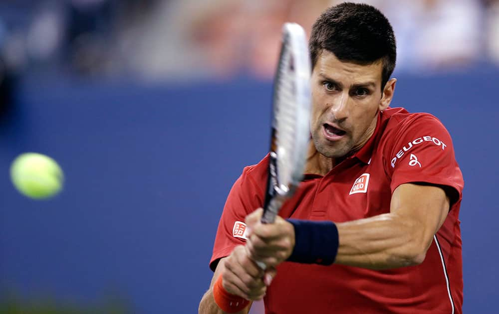 Novak Djokovic, of Serbia, returns a shot to Diego Schwartzman, of Argentina, during the opening round of the US Open tennis tournament.