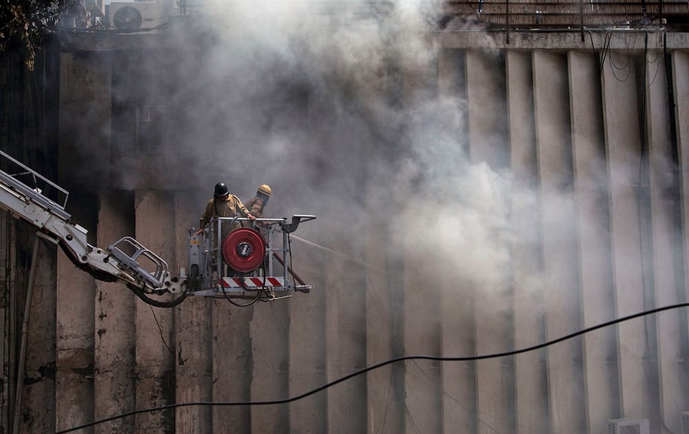 Fire officials douse a fire at a building in Connaught Place in New Delhi. No casualties have been reported so far and the cause of the fire is not known. Fire officials believe that the blaze broke out due to a short circuit in the electric wiring at the NIIT Center.