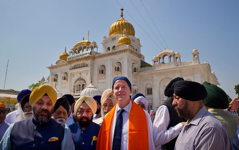 Britain`s Deputy Prime Minister Nick Clegg, poses for a photograph after paying obeisance at the Bangla Sahib Gurudwara or Sikh temple in New Delhi.