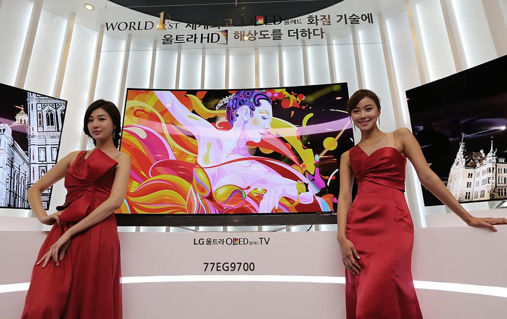 Models pose with LG Electronics` 77-inch Ultra organic light-emitting diode (OLED) TV during a press unveiling in Seoul, South Korea.