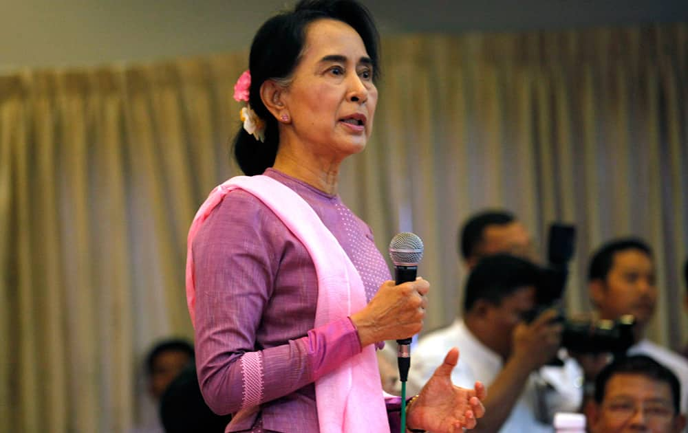 Myanmar opposition leader Aung San Suu Kyi speaks during a meeting with Myanmar artists at a restaurant in Yangon, Myanmar. 