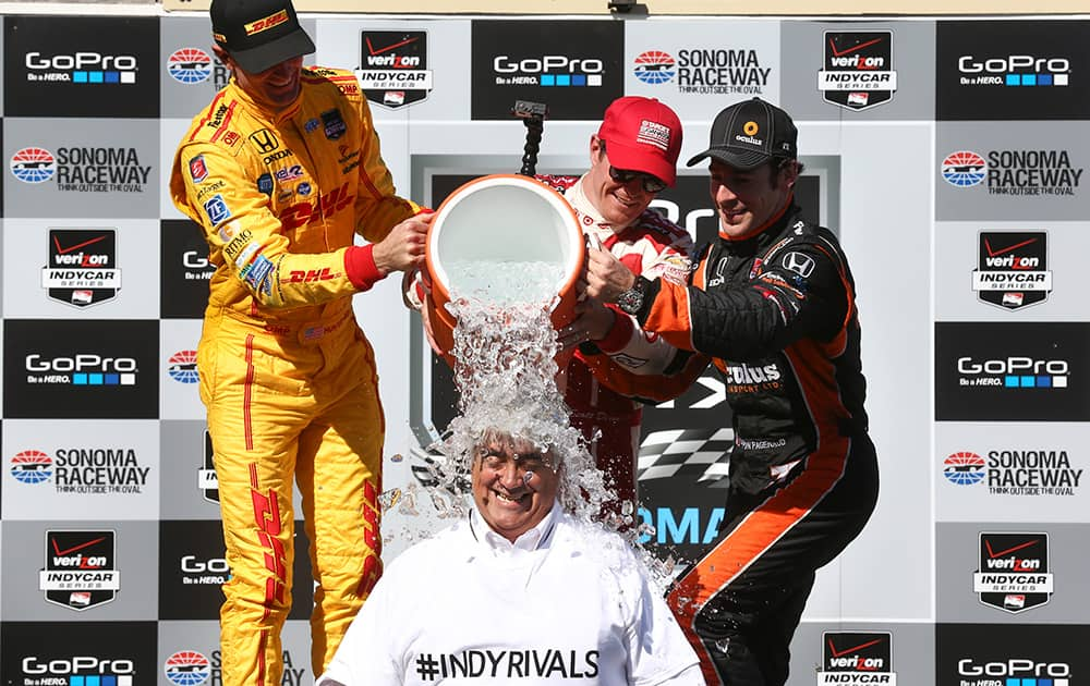 Mark Miles, bottom, CEO of Hulman and Co., participates in the Ice Bucket Challenge as the three winners of the GoPro Grand Prix of Sonoma IndyCar series auto race dump ice water on his head following the race in Sonoma, Calif. 