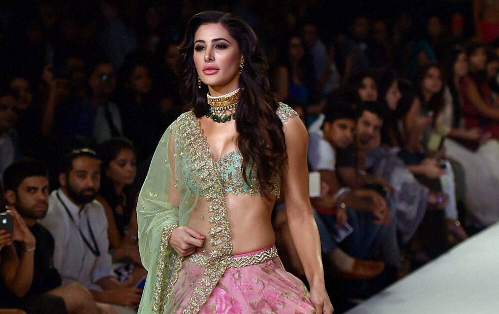 Bollywood actress Nargis Fakhri walks the ramp at Lakme Fashion Week Winter/Festive 2014 in Mumbai.