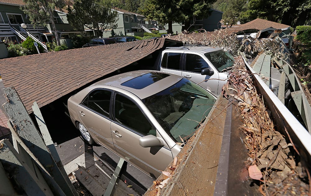 A carport is seen collapsed onto vehicles in Napa, Calif. Officials say an earthquake with a preliminary magnitude of 6.0 has been reported in California`s northern San Francisco Bay area.