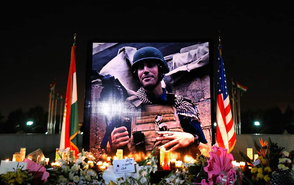 A photograph of James Foley, the freelance journalist killed by the IS group, is seen during a memorial service in Irbil, 350 kilometers (220 miles) north of Baghdad, Iraq.