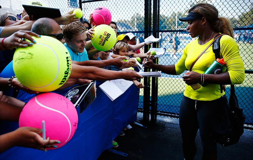 Serena Williams signs autographs after practicing ahead of the of the 2014 US Open tennis tournamen in New York.