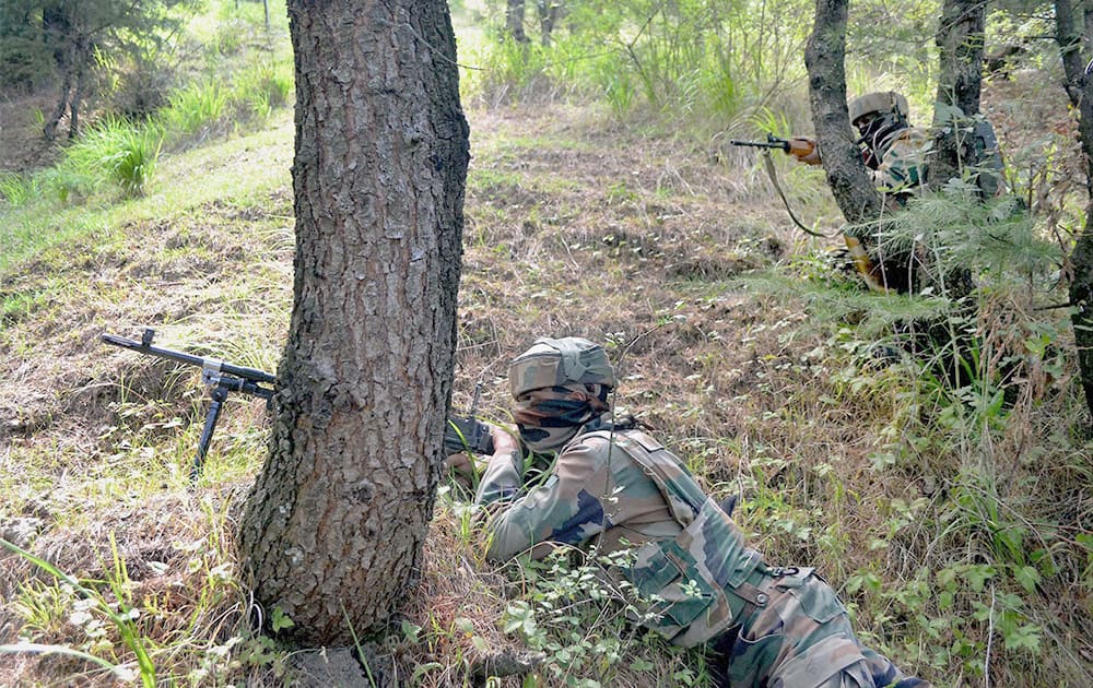 Army personnel take position during an encounter with militants in Kalaros, Kupwara.















