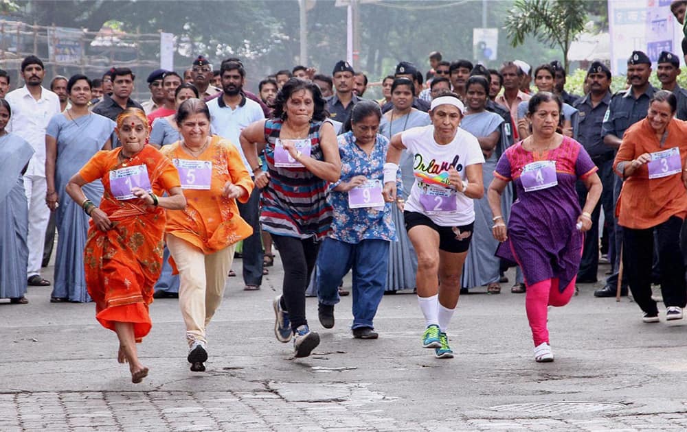 People participate in the 25th Annual Thane Monsoon Marathon in Thane.