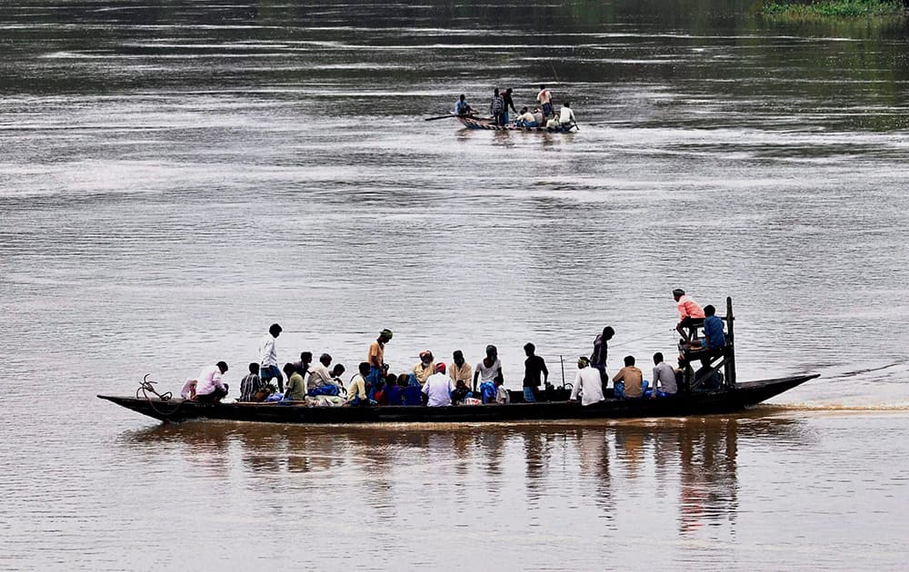 Villagers return back to their home in a boat through the Kollong river after the weekly market at Chandrapur in Kamrup district of Assam.