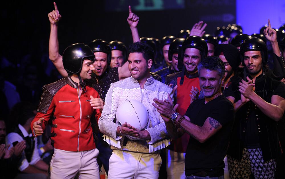 Cricketer Yuvraj Singh was the showstopper in an all white biker ensemble" walk the ramp in Arjun Khanna’s creation at the Lakme Fashion Week in Mumbai.