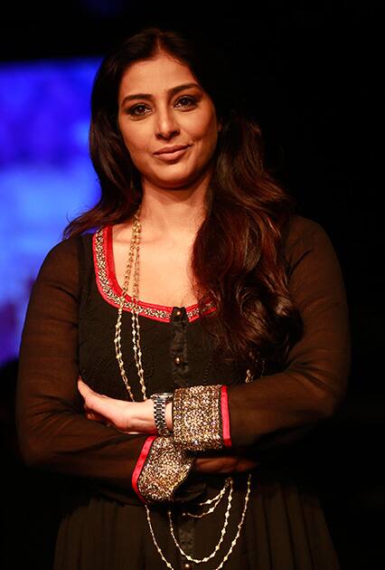 Tabu poses for photographs in the sidelines of the Lakme Fashion Week in Mumbai.