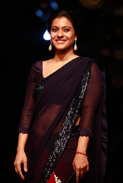 Kajol Devgan poses for photographs on the sidelines of the Lakme Fashion Week in Mumbai.