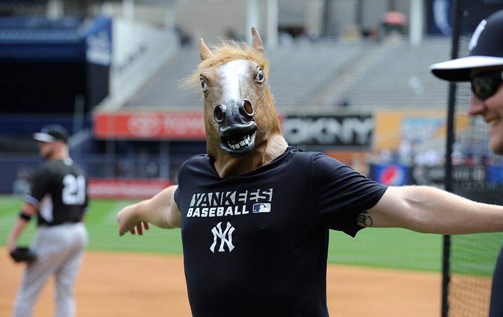 New York Yankees pitcher Shawn Kelley came out to stretch with a horse head mask on before a baseball game against the Chicago White Sox, at Yankee Stadium in New York.