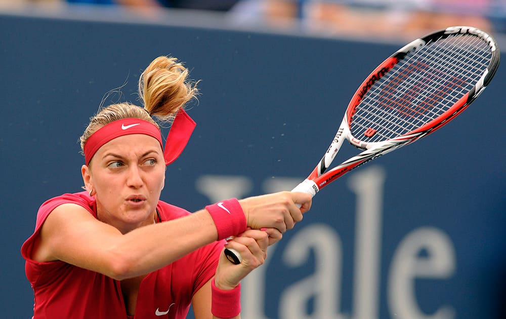 Petra Kvitova, of the Czech Republic, hits a backhand during her 6-4, 6-2 victory over Magdalena Rybarikova, of Slovakia, in the final match of the Connecticut Open tennis tournament in New Haven, Conn.