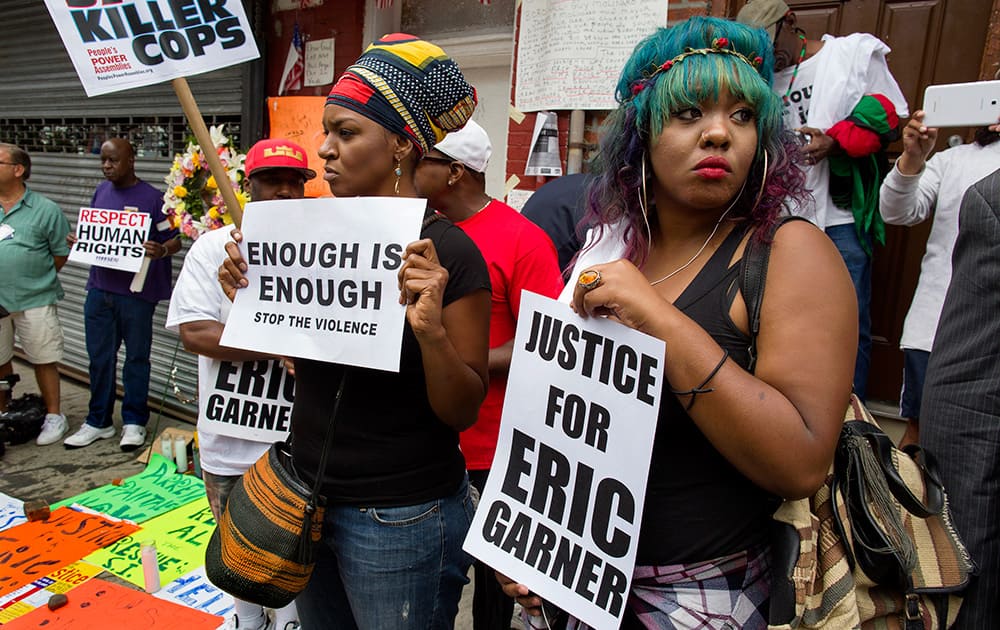 Marchers stand near a memorial in the Staten Island borough of New York.