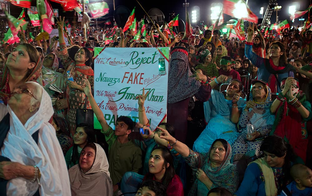 Supporters of Pakistan`s cricket celebrity-turned-politician Imran Khan listen to their leader at a rally in Islamabad, Pakistan.