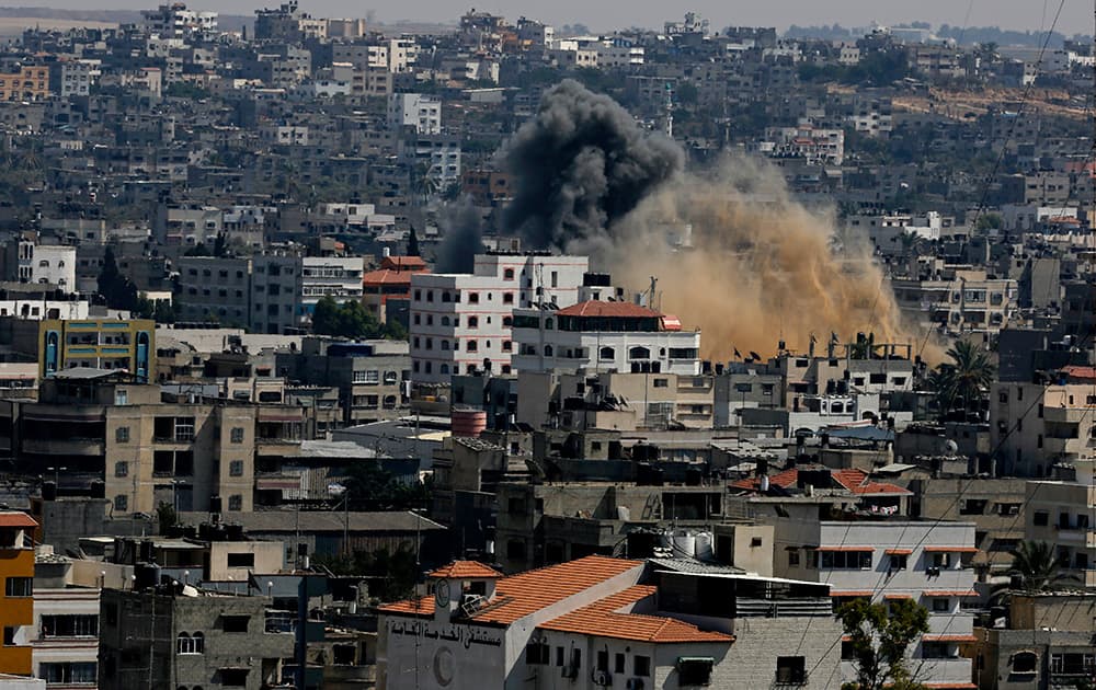 Smoke and dust rise after an Israeli strike hits Gaza City in the northern Gaza Strip.