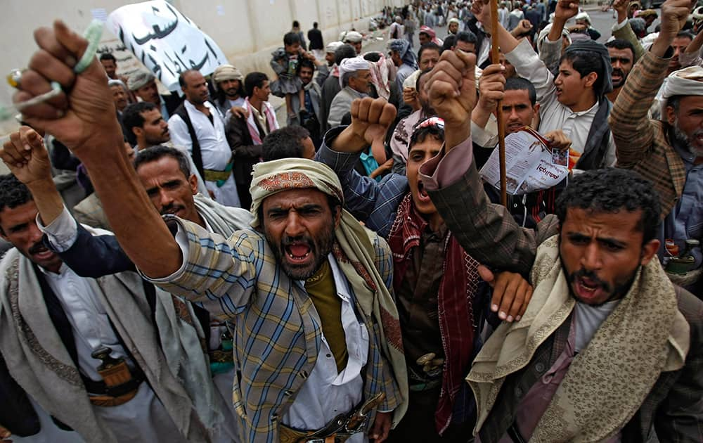 Yemeni Shiite Hawthi rebels chant slogans demanding the government step down during a demonstration in a street leading to the Interior Ministry in Sanaa, Yemen.