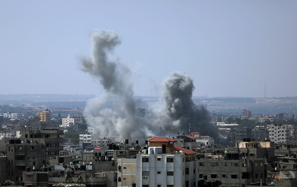 Smoke raises up in the sky following Israeli airstrikes in Gaza City.