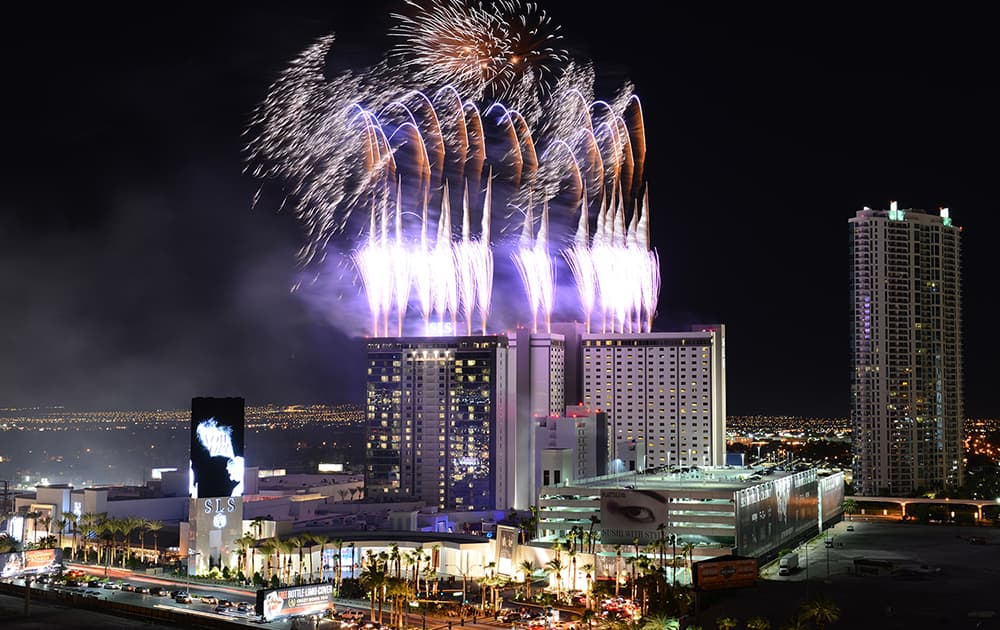 This photo provided by the Las Vegas News Bureau, fireworks erupt over the SLS Las Vegas during a grand opening celebration on the Las Vegas Strip.