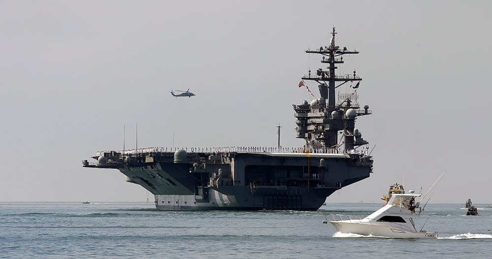 The aircraft carrier USS Carl Vinson sails out of San Diego Harbor as it leaves for a nine month deployment, in San Diego.