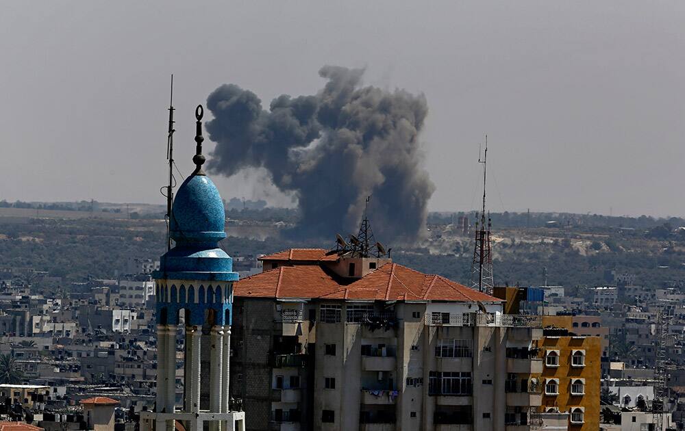 Smoke and dust rise after an Israeli strike hits Gaza City in the northern Gaza Strip.