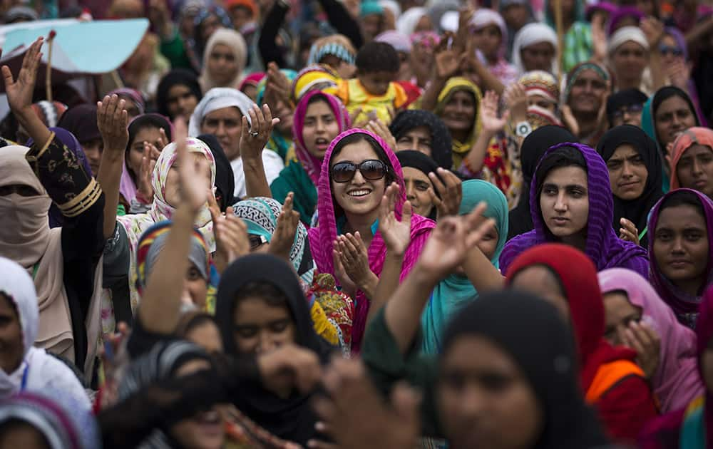 Supporters of Pakistan`s fiery cleric Tahir-ul-Qadri praise their leader`s speech in Islamabad, Pakistan.