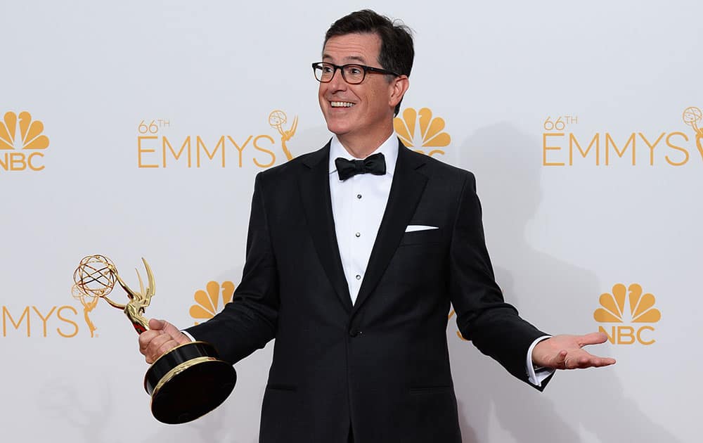 Stephen Colbert poses with the award for Outstanding Variety Series in the press room at the 66th Annual Primetime Emmy Awards at the Nokia Theatre L.A. 