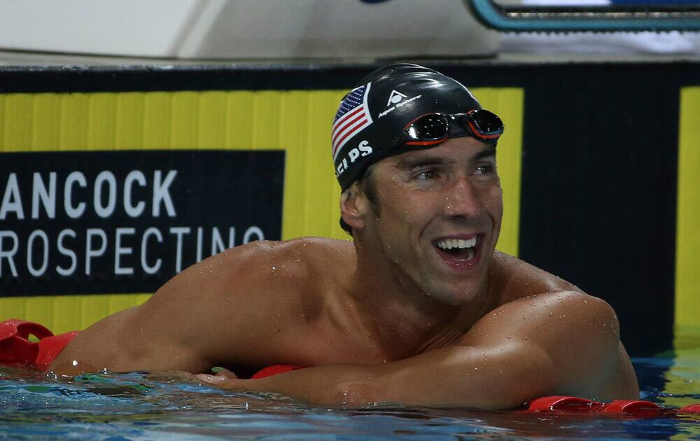 Michael Phelps of the US leans on a lane rope after his men`s 100m freestyle final at the Pan Pacific swimming championships in Gold Coast, Australia.