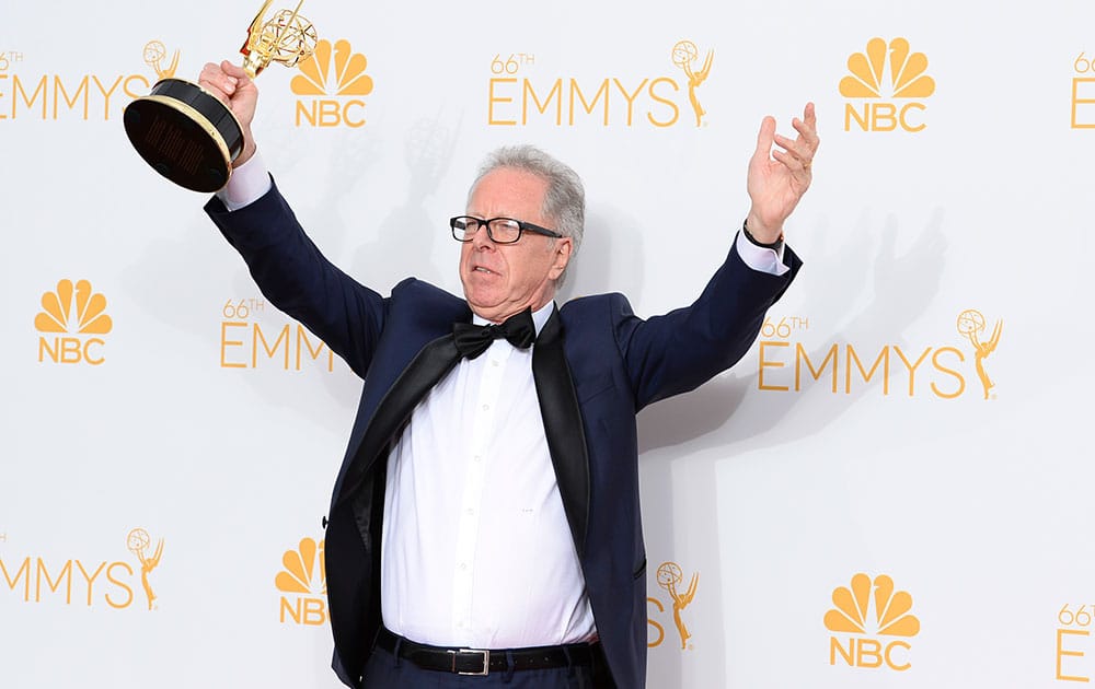 Colin Bucksey, winner of the Outstanding Director, poses in the press room at the 66th Annual Primetime Emmy Awards at the Nokia Theatre L.A. 