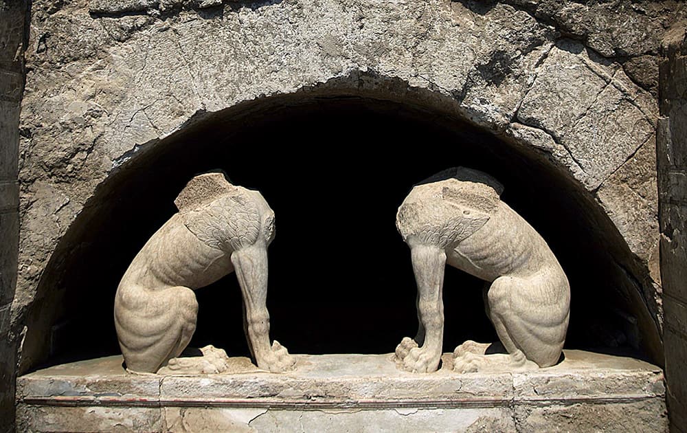 This handout photo released by the Greek Culture Ministry, two large stone sphinxes are seen under a barrel-vault topping the entrance to an ancient tomb under excavation at Amphipolis in northern Greece. 