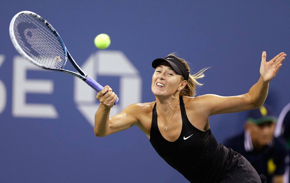 Maria Sharapova, of Russia, returns a shot to Maria Kirilenko, of Russia, during the opening round of the U.S. Open tennis tournament in New York. 