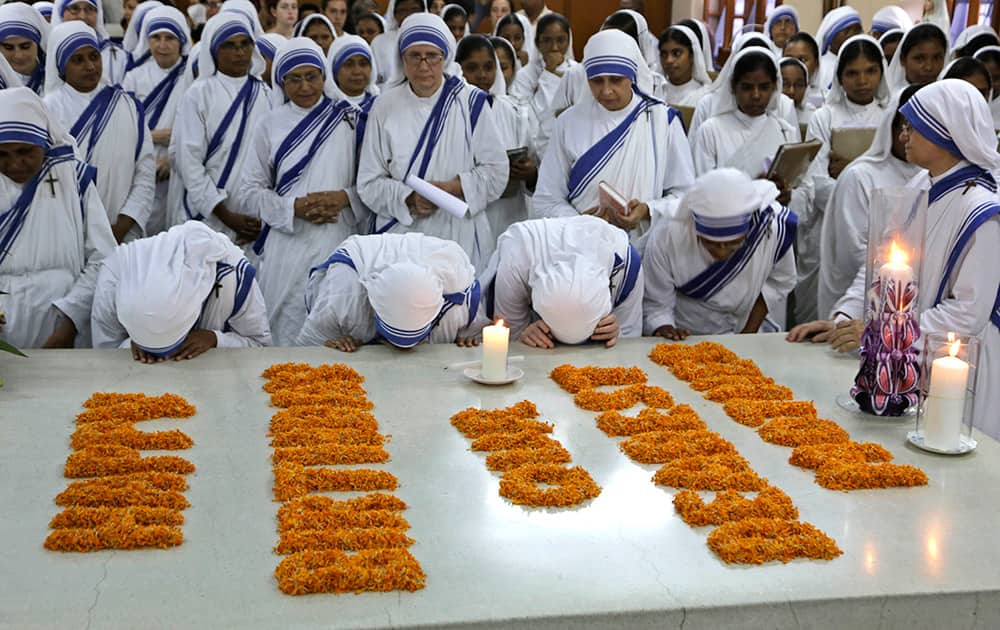 Nuns of Missionaries of Charity kiss the tomb of Mother Teresa during a mass on her birth anniversary in Kolkata.