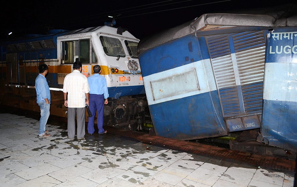 Officials inspect the damage after a locomotive engine hit a stationery train at Banipur railway station in Dibrugarh.