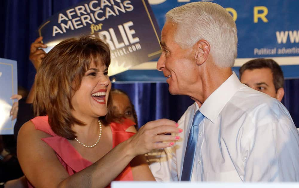 Former Republican Gov. Charlie Crist, right, hugs his running mate Annette Taddeo after speaking to supporters at a victory party after Florida's primary election.